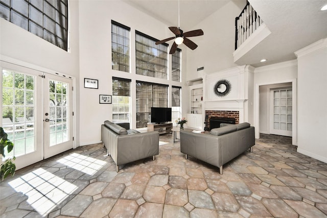 7923 Vintage Creek Dr, Spring, TX 77379 - living area with a ceiling fan, baseboards, french doors, a high ceiling, and a brick fireplace