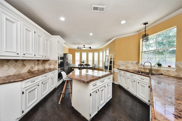 7923 Vintage Creek Dr, Spring, TX 77379 - kitchen with a sink, healthy amount of natural light, white cabinets, recessed lighting, and dark wood-style floors