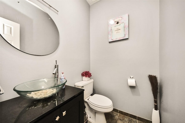 7923 Vintage Creek Dr, Spring, TX 77379 - half bathroom featuring vanity, toilet, baseboards, and stone finish flooring