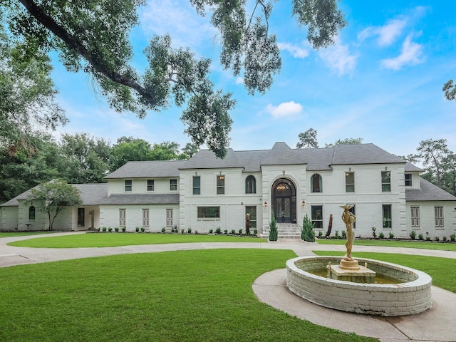 23226 Oak Hollow Ln, Tomball, TX 77377 - french country inspired facade with a front lawn