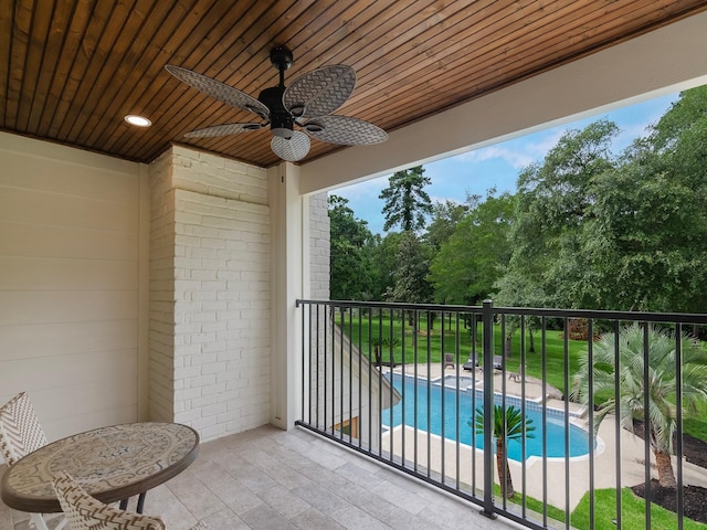 23226 Oak Hollow Ln, Tomball, TX 77377 - balcony featuring view of pool, a ceiling fan, and view of scattered trees