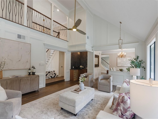 23226 Oak Hollow Ln, Tomball, TX 77377 - living room featuring high vaulted ceiling, stairway, wood finished floors, a chandelier, and ceiling fan