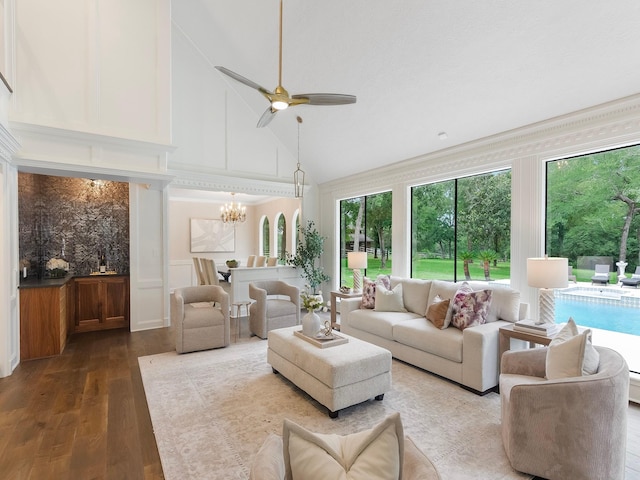 23226 Oak Hollow Ln, Tomball, TX 77377 - living area featuring a decorative wall, healthy amount of natural light, wood finished floors, a chandelier, and high vaulted ceiling