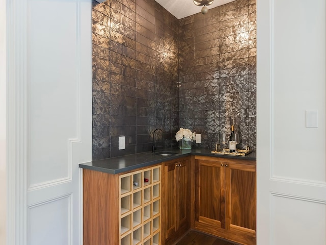 23226 Oak Hollow Ln, Tomball, TX 77377 - wine room with bar with sink and dark wood-style floors