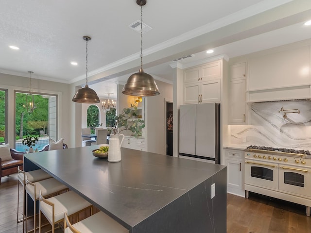 23226 Oak Hollow Ln, Tomball, TX 77377 - kitchen featuring freestanding refrigerator, range with two ovens, dark wood-style floors, a chandelier, and white cabinets