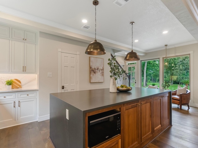23226 Oak Hollow Ln, Tomball, TX 77377 - kitchen with black microwave, dark wood-style flooring, white cabinetry, dark countertops, and recessed lighting