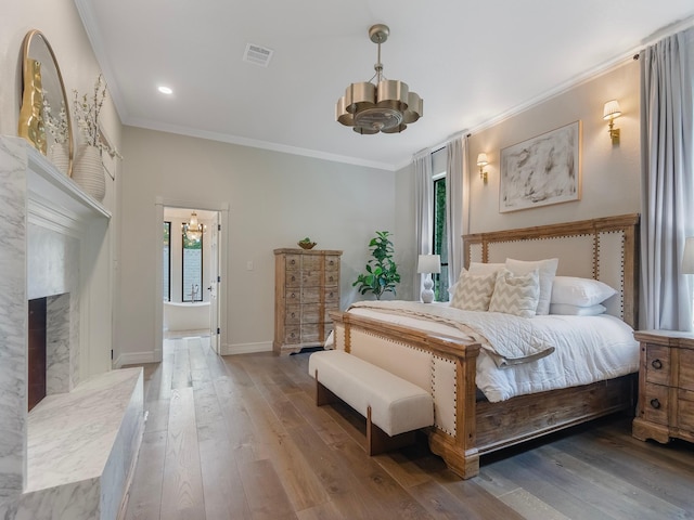 23226 Oak Hollow Ln, Tomball, TX 77377 - bedroom with a chandelier, ornamental molding, multiple windows, wood finished floors, and recessed lighting