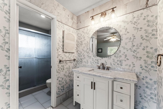 6103 Sunnygate Dr, Spring, TX 77373 - bathroom with tile patterned floors, toilet, vanity, ceiling fan, and plenty of natural light