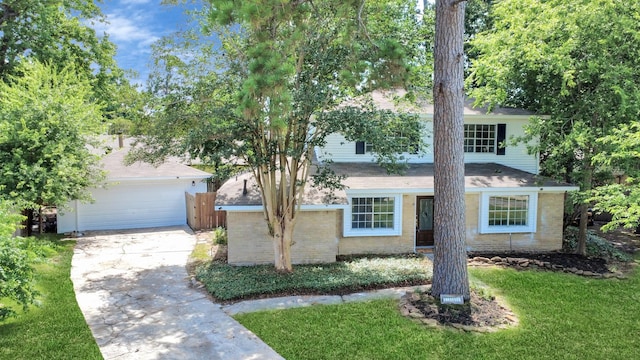 2302 Sun Spring Ct, Spring, TX 77373 - view of property hidden behind natural elements featuring driveway, brick siding, and an attached garage