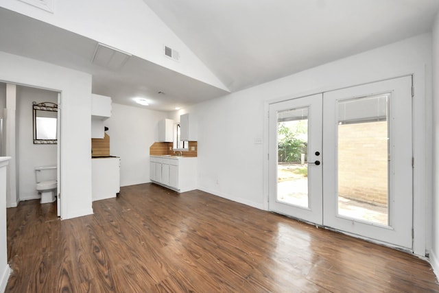 2302 Sun Spring Ct, Spring, TX 77373 - unfurnished living room featuring french doors, lofted ceiling, dark wood-type flooring, and a sink