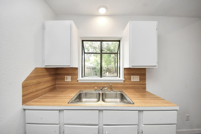2302 Sun Spring Ct, Spring, TX 77373 - kitchen with a sink, light countertops, and white cabinetry