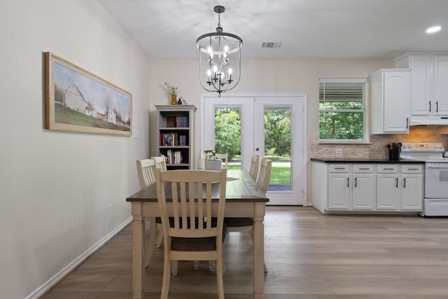 11402 Willis Waukegan Rd, Conroe, TX 77303 - dining space featuring a chandelier, french doors, light wood-style flooring, baseboards, and recessed lighting
