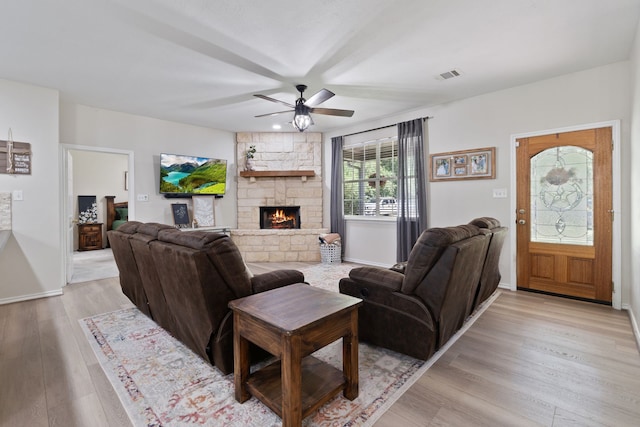 11402 Willis Waukegan Rd, Conroe, TX 77303 - living area with a ceiling fan, light wood-style floors, a fireplace, and baseboards