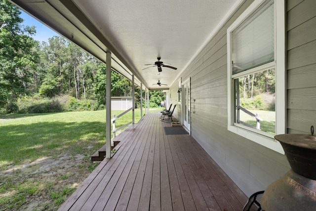 11402 Willis Waukegan Rd, Conroe, TX 77303 - wooden deck with a yard, ceiling fan, and an outdoor structure