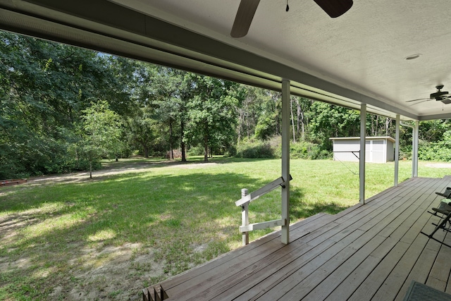11402 Willis Waukegan Rd, Conroe, TX 77303 - wooden terrace featuring ceiling fan, a lawn, and view of scattered trees