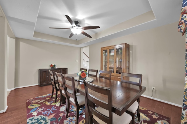20530 Saddleback Chase Ln, Cypress, TX 77433 - dining area with a tray ceiling, a ceiling fan, wood finished floors, stairs, and baseboards