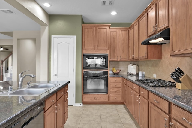 20530 Saddleback Chase Ln, Cypress, TX 77433 - kitchen featuring black appliances, under cabinet range hood, a sink, and brown cabinets