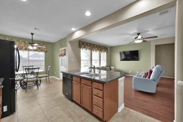 20530 Saddleback Chase Ln, Cypress, TX 77433 - kitchen with black appliances, a sink, dark countertops, brown cabinets, and open floor plan