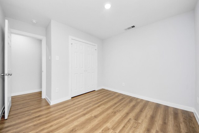 6617 Bacher St, Houston, TX 77028 - unfurnished bedroom with baseboards, light wood finished floors, and a closet