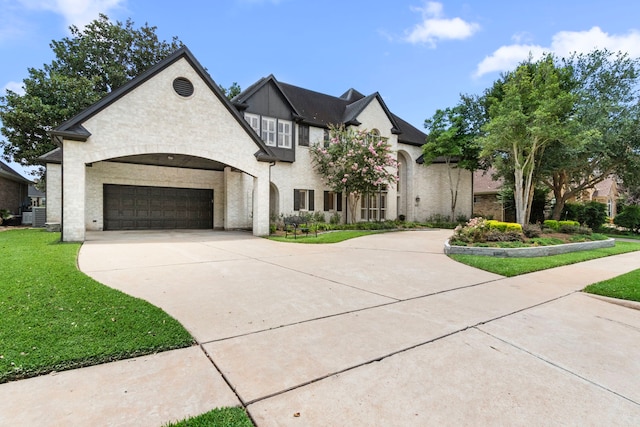 2623 Old S Dr, Richmond, TX 77406 - french country home featuring driveway, a front yard, a garage, and central AC unit