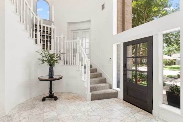 2623 Old S Dr, Richmond, TX 77406 - foyer entrance featuring a high ceiling, healthy amount of natural light, stairs, marble tiled floors, and baseboards