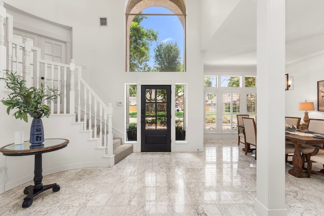 2623 Old S Dr, Richmond, TX 77406 - entryway featuring a towering ceiling, marble tiled flooring, stairs, and decorative columns