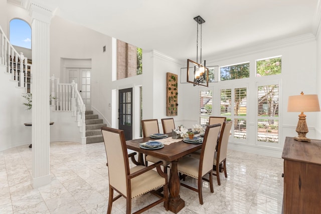 2623 Old S Dr, Richmond, TX 77406 - dining room with stairway, light marble finish floors, a towering ceiling, a chandelier, and crown molding