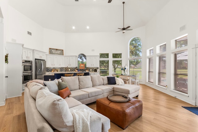 2623 Old S Dr, Richmond, TX 77406 - living area with a high ceiling, a ceiling fan, and light wood-type flooring