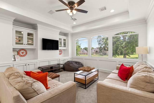 2623 Old S Dr, Richmond, TX 77406 - living area featuring light colored carpet, a ceiling fan, a decorative wall, crown molding, and a raised ceiling