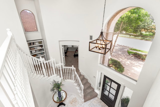 2623 Old S Dr, Richmond, TX 77406 - foyer entrance with a high ceiling, a chandelier, stairs, and baseboards