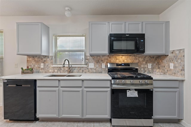 19126 Edens Dawn Dr, Tomball, TX 77375 - kitchen featuring black microwave, dishwasher, gas range, a sink, and gray cabinets