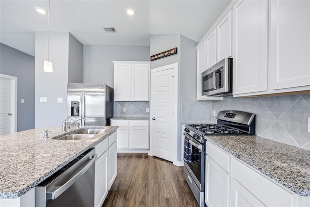 2030 Boreas Ln, Baytown, TX 77523 - kitchen with appliances with stainless steel finishes, a sink, dark wood-style floors, light stone countertops, and white cabinetry