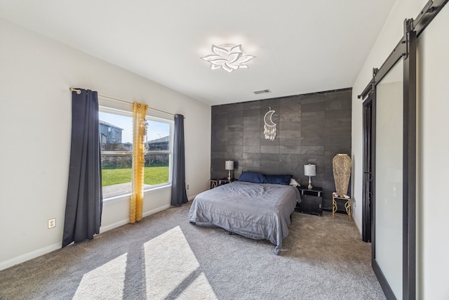 15203 Albert Oak Dr, Humble, TX 77396 - carpeted bedroom featuring a barn door and baseboards