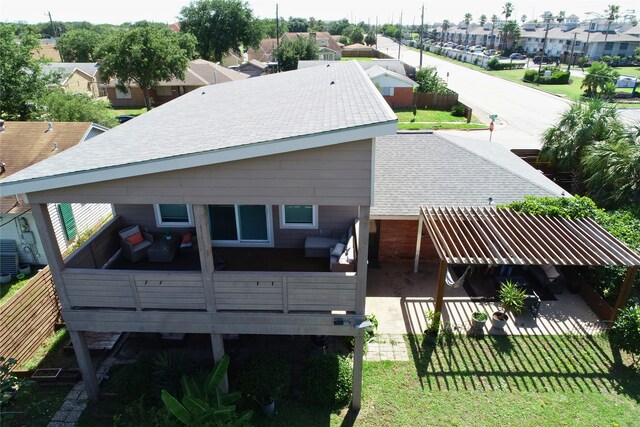 2402 Pine St, Galveston, TX 77551 - back of house featuring a shingled roof, a residential view, a wooden deck, and a lawn