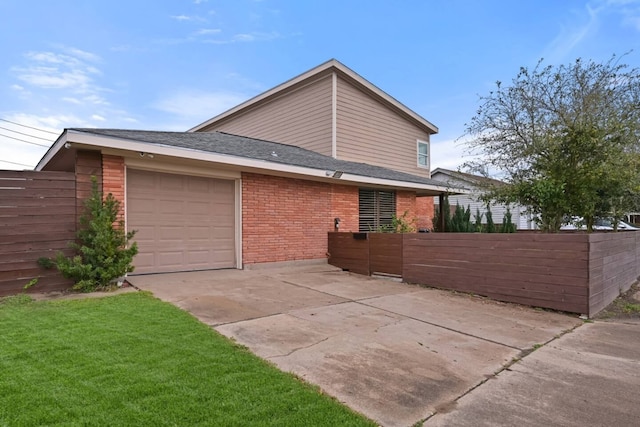 2402 Pine St, Galveston, TX 77551 - view of side of property featuring a garage, concrete driveway, brick siding, and a shingled roof