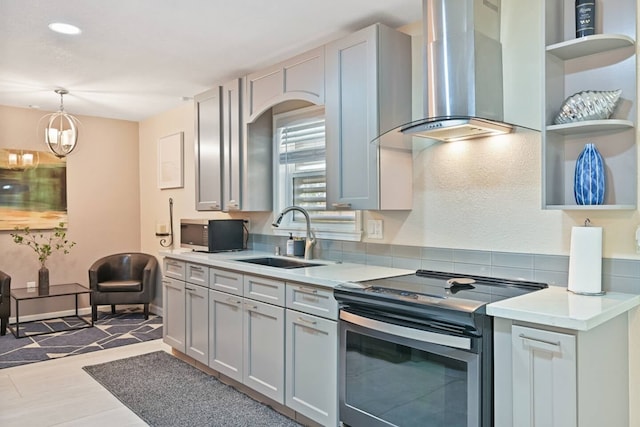 2402 Pine St, Galveston, TX 77551 - kitchen featuring island range hood, stainless steel range with electric stovetop, a sink, and light countertops
