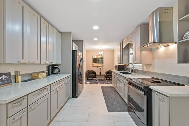2402 Pine St, Galveston, TX 77551 - kitchen featuring appliances with stainless steel finishes, wall chimney exhaust hood, a sink, recessed lighting, and light tile patterned floors