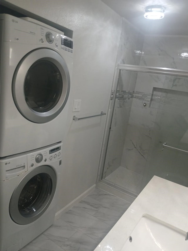 12500 Sandpiper Dr Unit 66, Houston, TX 77035 - bathroom with stacked washing machine and dryer, marble finish floors, and a shower stall