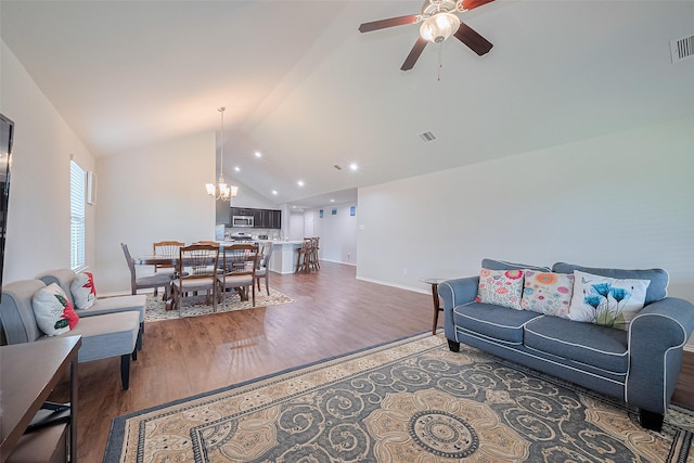 21018 Whitehaven Bluff Trl, Katy, TX 77449 - living area with a chandelier, ceiling fan, wood finished floors, vaulted ceiling, and baseboards