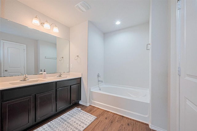 21018 Whitehaven Bluff Trl, Katy, TX 77449 - full bath featuring double vanity, a garden tub, wood finished floors, and recessed lighting