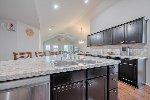 21018 Whitehaven Bluff Trl, Katy, TX 77449 - kitchen with dishwasher, a sink, lofted ceiling, light countertops, and light wood-style floors