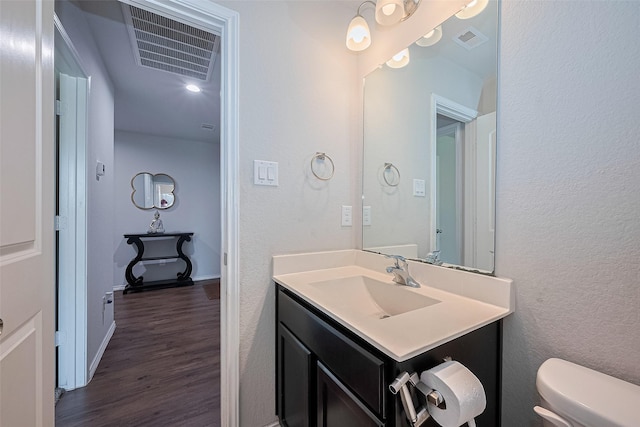21018 Whitehaven Bluff Trl, Katy, TX 77449 - half bath featuring vanity, wood finished floors, toilet, and baseboards