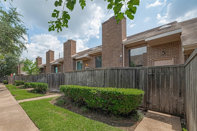 13798 Hollowgreen Dr Unit 305, Houston, TX 77082 - view of property exterior featuring brick siding and a chimney