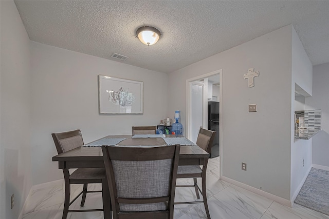 13798 Hollowgreen Dr Unit 305, Houston, TX 77082 - dining space featuring light marble finish flooring and a textured ceiling