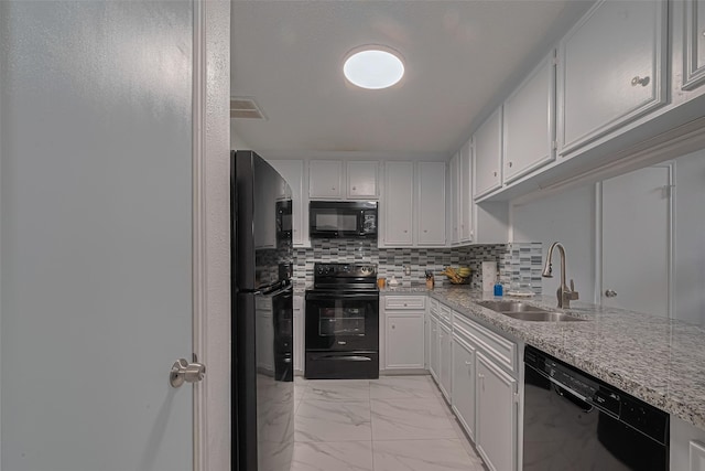 13798 Hollowgreen Dr Unit 305, Houston, TX 77082 - kitchen featuring black appliances, light marble finish flooring, tasteful backsplash, white cabinets, and light stone countertops