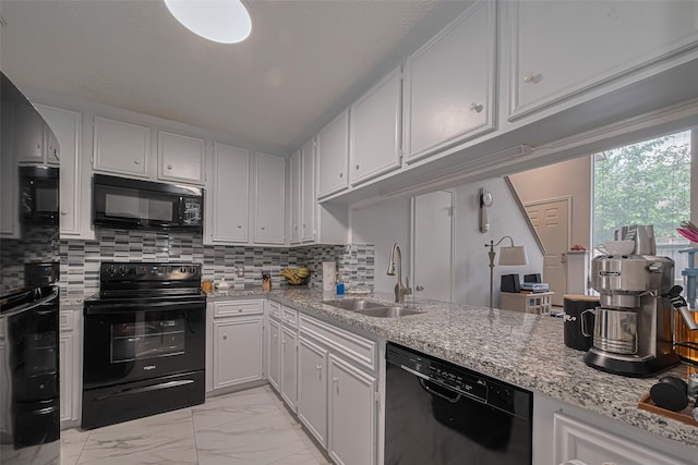 13798 Hollowgreen Dr Unit 305, Houston, TX 77082 - kitchen with black appliances, light marble finish flooring, white cabinetry, decorative backsplash, and light stone counters