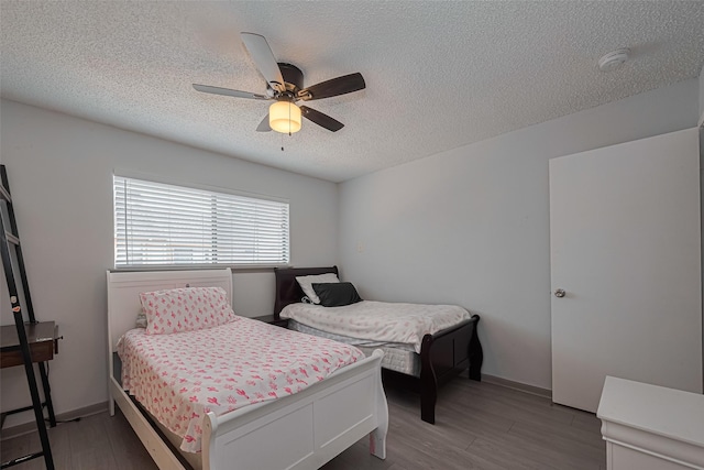13798 Hollowgreen Dr Unit 305, Houston, TX 77082 - bedroom with a textured ceiling, light wood-type flooring, and ceiling fan