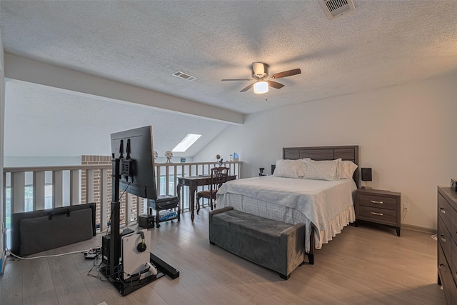 13798 Hollowgreen Dr Unit 305, Houston, TX 77082 - bedroom featuring a skylight, wood finished floors, a textured ceiling, multiple windows, and ceiling fan