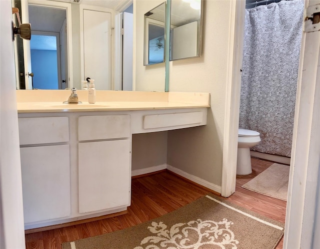 2120 El Paseo St Unit 310, Houston, TX 77054 - full bathroom featuring toilet, baseboards, wood finished floors, and vanity