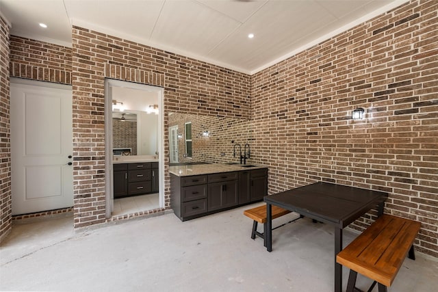58-D Hickory Ridge Dr, Huffman, TX 77336 - interior space featuring a sink, brick wall, recessed lighting, and concrete flooring